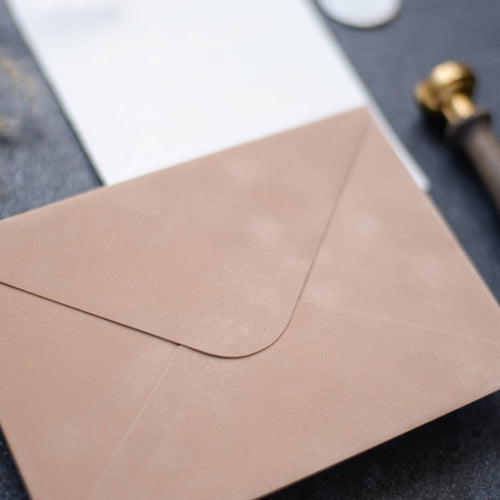 Close-up of a cream velvet paper envelope showing its soft textured surface